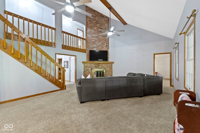10808 Greenbriar Dr, Fishers, IN 46037 - living room with a ceiling fan, carpet, high vaulted ceiling, stairs, and a fireplace