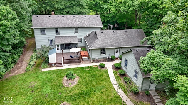 10808 Greenbriar Dr, Fishers, IN 46037 - rear view of house with a deck, roof with shingles, a chimney, and a yard