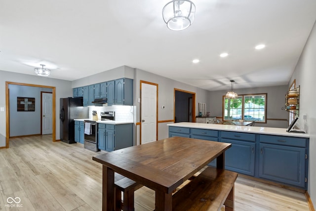 10808 Greenbriar Dr, Fishers, IN 46037 - kitchen with blue cabinetry, stainless steel electric range oven, black fridge, light countertops, and light wood-style floors