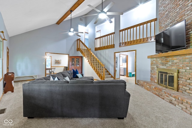 10808 Greenbriar Dr, Fishers, IN 46037 - carpeted living area with a ceiling fan, high vaulted ceiling, stairs, a brick fireplace, and beam ceiling