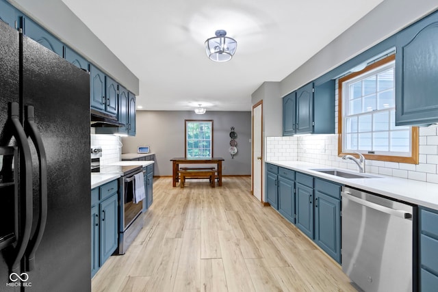 10808 Greenbriar Dr, Fishers, IN 46037 - kitchen featuring stainless steel appliances, blue cabinetry, under cabinet range hood, and light countertops