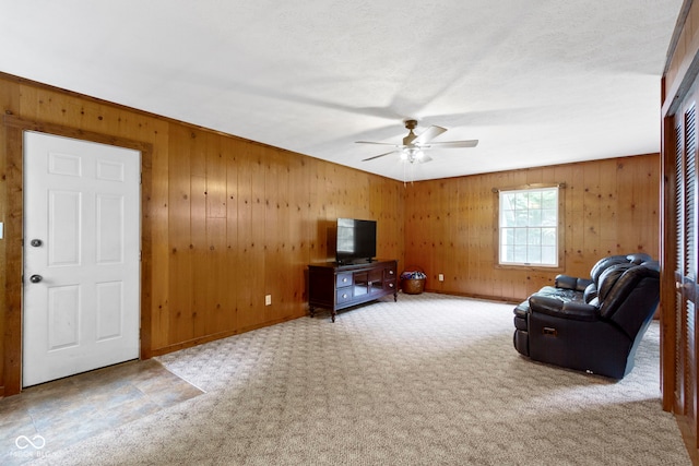 10808 Greenbriar Dr, Fishers, IN 46037 - living room with ceiling fan, wood walls, and carpet
