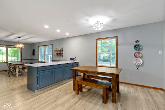 10808 Greenbriar Dr, Fishers, IN 46037 - kitchen featuring blue cabinets, light countertops, light wood-type flooring, a chandelier, and recessed lighting