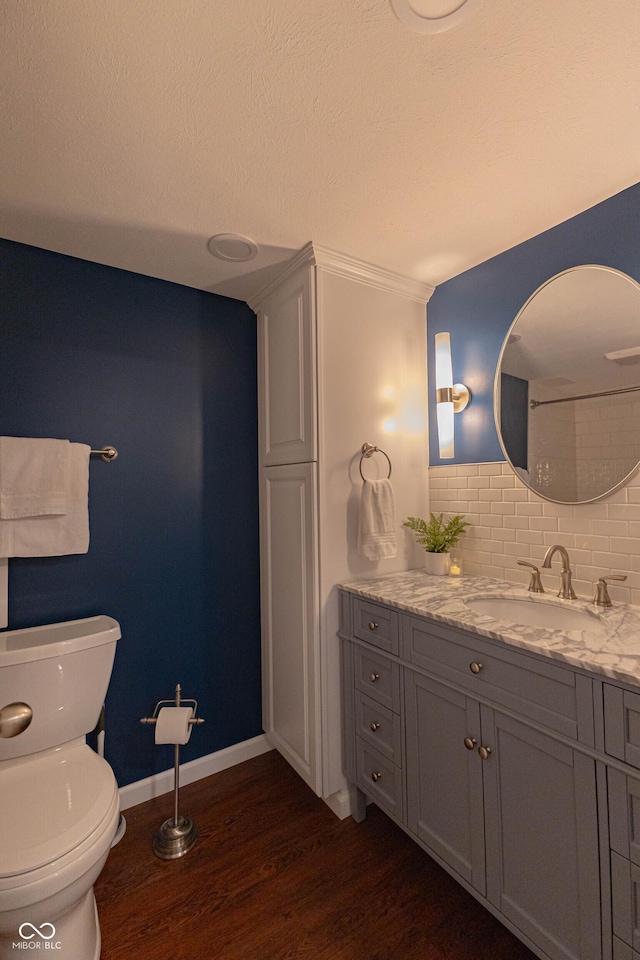 5609 Meadowood Dr, Indianapolis, IN 46224 - bathroom with wood finished floors, vanity, and backsplash