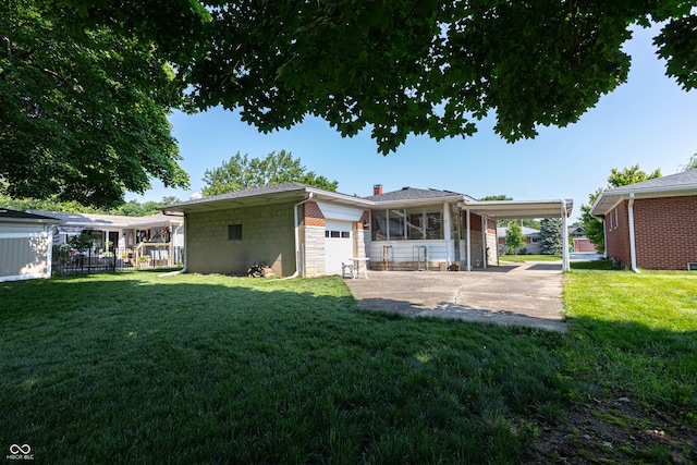 5609 Meadowood Dr, Indianapolis, IN 46224 - back of house with concrete driveway, a garage, a chimney, a carport, and stone siding