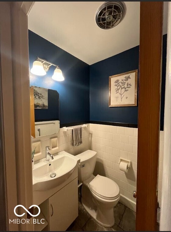 5609 Meadowood Dr, Indianapolis, IN 46224 - bathroom featuring tile walls, vanity, tile patterned flooring, and wainscoting