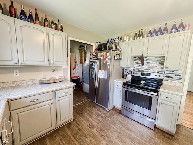 3613 N Locust St, Muncie, IN 47304 - kitchen featuring appliances with stainless steel finishes, wood finished floors, light countertops, and decorative backsplash