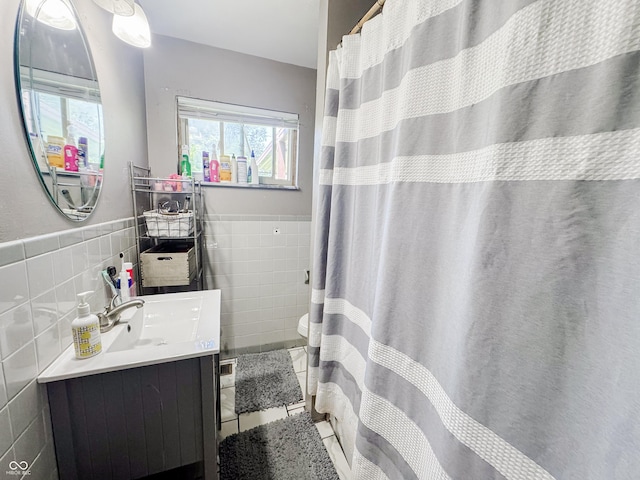 3613 N Locust St, Muncie, IN 47304 - full bathroom with tile walls, vanity, wainscoting, and tile patterned floors