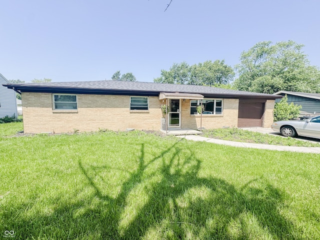 3613 N Locust St, Muncie, IN 47304 - single story home with brick siding, an attached garage, and a front lawn