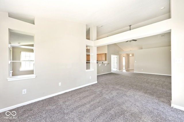 10668 Whippoorwill Ln, Indianapolis, IN 46231 - unfurnished living room featuring carpet floors, lofted ceiling, and a ceiling fan
