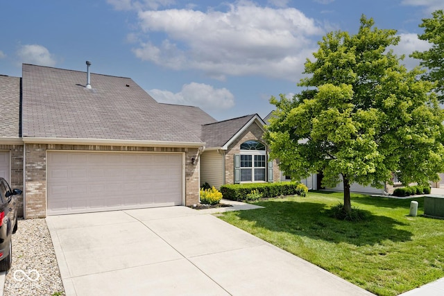 10668 Whippoorwill Ln, Indianapolis, IN 46231 - view of front of home featuring brick siding, driveway, an attached garage, a front yard, and a shingled roof