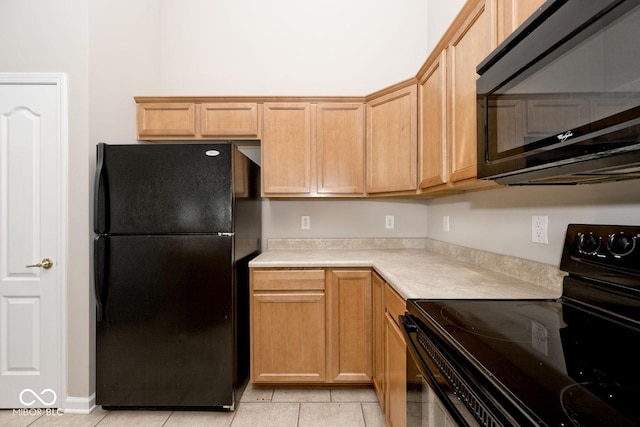 10668 Whippoorwill Ln, Indianapolis, IN 46231 - kitchen featuring black appliances, light countertops, and light tile patterned floors