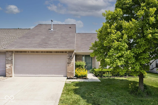 10668 Whippoorwill Ln, Indianapolis, IN 46231 - view of front facade with brick siding, an attached garage, driveway, and a front yard