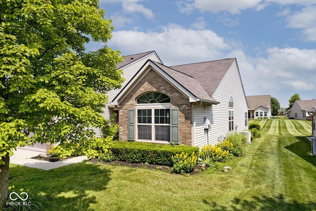 10668 Whippoorwill Ln, Indianapolis, IN 46231 - view of property exterior with brick siding, a lawn, and a shingled roof