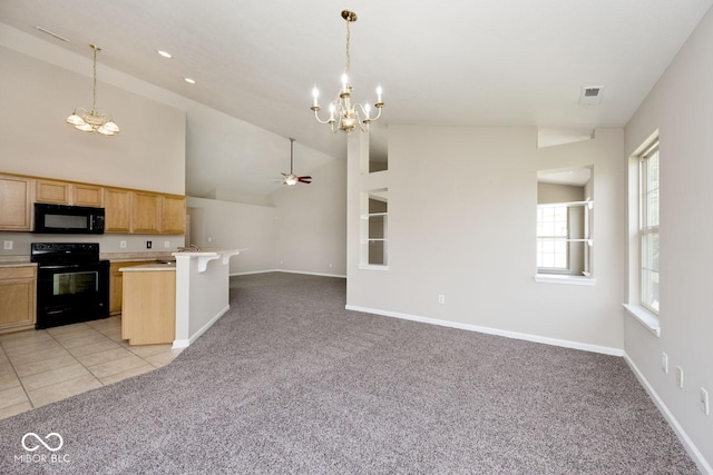 10668 Whippoorwill Ln, Indianapolis, IN 46231 - kitchen featuring black appliances, a chandelier, open floor plan, light colored carpet, and high vaulted ceiling