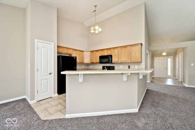 10668 Whippoorwill Ln, Indianapolis, IN 46231 - kitchen with black appliances, high vaulted ceiling, light colored carpet, a breakfast bar, and a chandelier