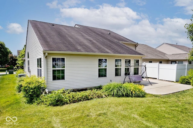 10668 Whippoorwill Ln, Indianapolis, IN 46231 - back of property featuring a patio area and roof with shingles
