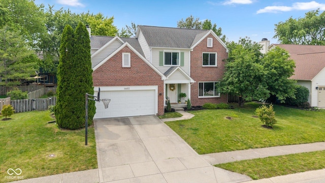 14492 Cotswold Ln, Carmel, IN 46033 - traditional home with brick siding, concrete driveway, and a garage