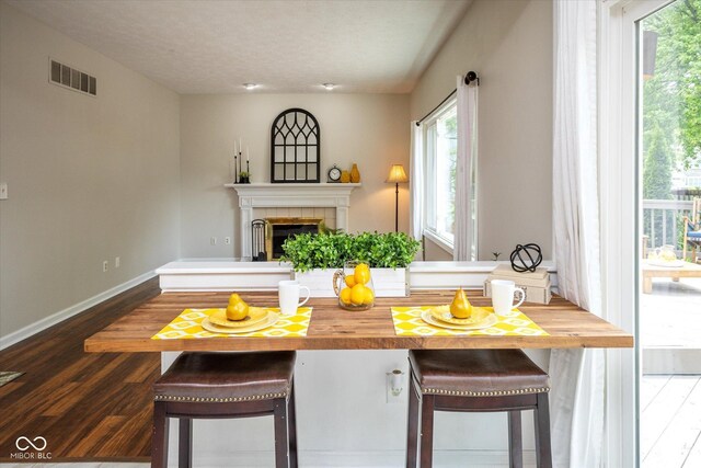 14492 Cotswold Ln, Carmel, IN 46033 - dining room with dark wood-style floors and a fireplace