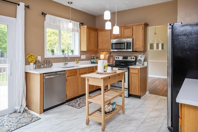 14492 Cotswold Ln, Carmel, IN 46033 - kitchen featuring stainless steel appliances, light countertops, light marble finish flooring, decorative light fixtures, and brown cabinets