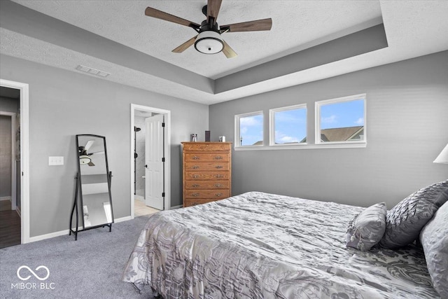 4420 Wild Turkey Dr, Indianapolis, IN 46239 - carpeted bedroom with a textured ceiling, ceiling fan, a tray ceiling, and ensuite bathroom