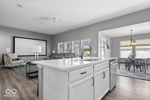 4420 Wild Turkey Dr, Indianapolis, IN 46239 - kitchen with stainless steel dishwasher, dark wood finished floors, open floor plan, light countertops, and a chandelier