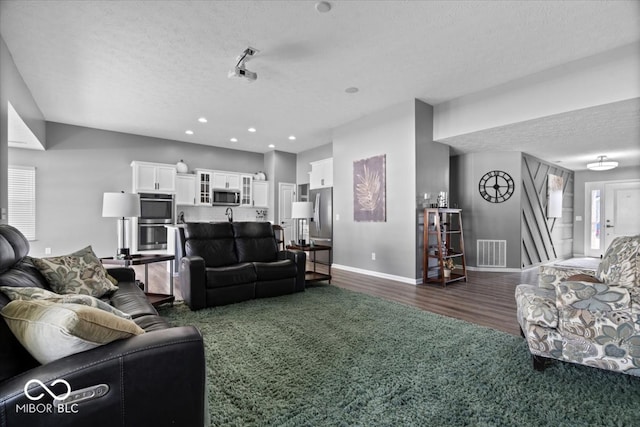 4420 Wild Turkey Dr, Indianapolis, IN 46239 - living area with a textured ceiling, dark wood-style flooring, healthy amount of natural light, and recessed lighting