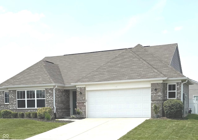 4420 Wild Turkey Dr, Indianapolis, IN 46239 - ranch-style home featuring an attached garage, concrete driveway, a front lawn, brick siding, and a shingled roof