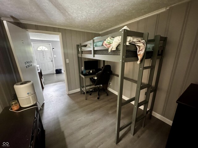 306 Waynetown Rd, Crawfordsville, IN 47933 - bedroom with a textured ceiling, ornamental molding, a desk, and wood finished floors