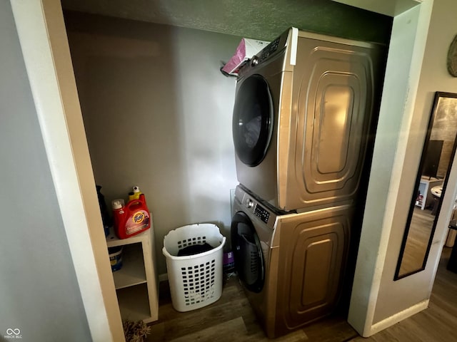306 Waynetown Rd, Crawfordsville, IN 47933 - laundry area featuring stacked washing machine and dryer and wood finished floors