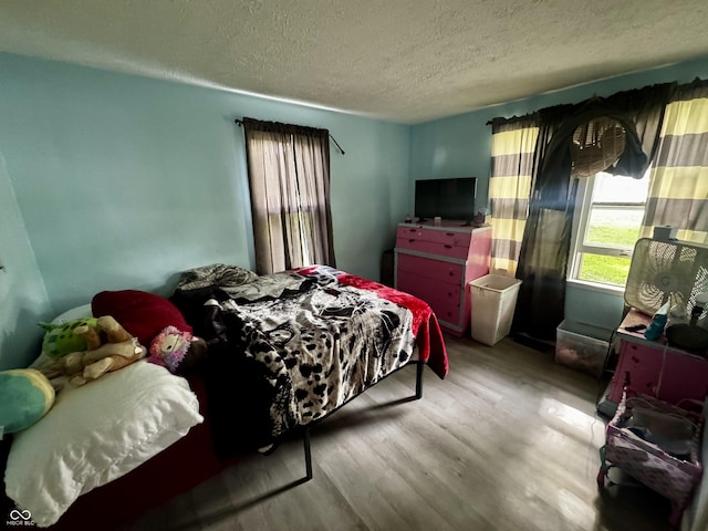 306 Waynetown Rd, Crawfordsville, IN 47933 - bedroom with wood finished floors and a textured ceiling