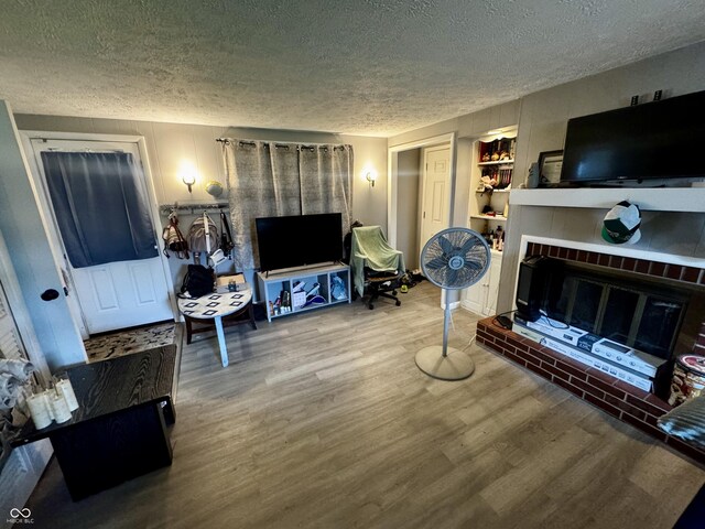 306 Waynetown Rd, Crawfordsville, IN 47933 - living area with a textured ceiling, wood finished floors, and a fireplace