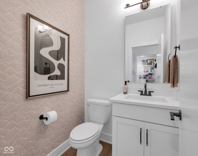 1834 Rosette Way, Indianapolis, IN 46202 - bathroom with wallpapered walls, vanity, and wood finished floors
