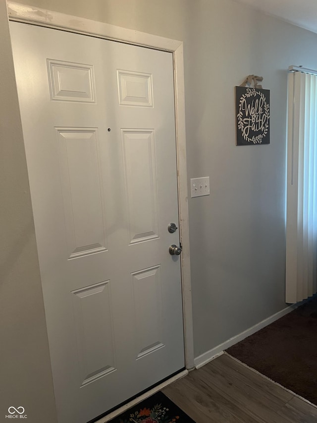 9016 Neptune Dr, Indianapolis, IN 46229 - doorway to outside with dark wood finished floors and baseboards