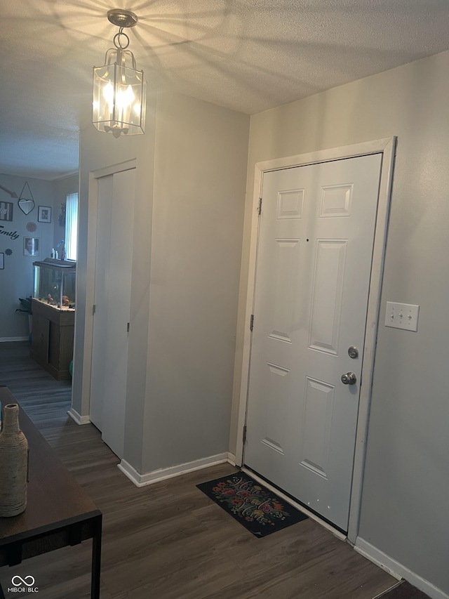 9016 Neptune Dr, Indianapolis, IN 46229 - entryway featuring wood finished floors, a chandelier, and a textured ceiling
