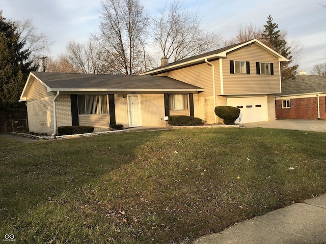 9016 Neptune Dr, Indianapolis, IN 46229 - view of front facade featuring brick siding, driveway, a garage, and a front lawn