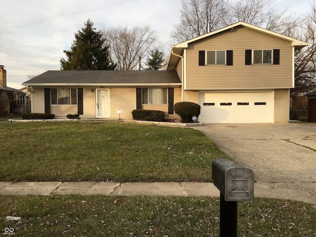 9016 Neptune Dr, Indianapolis, IN 46229 - split level home with brick siding, concrete driveway, a garage, and a front yard