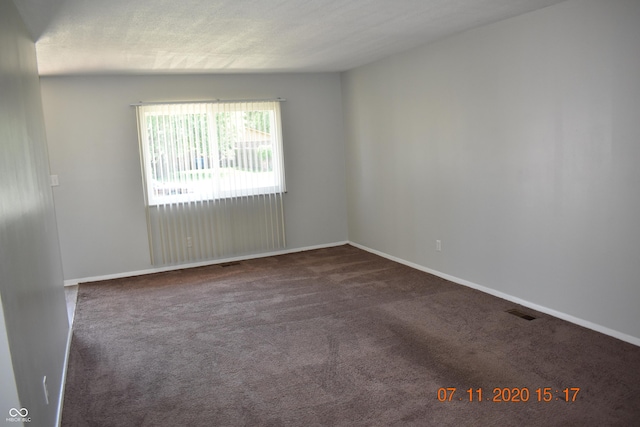 9016 Neptune Dr, Indianapolis, IN 46229 - empty room featuring dark colored carpet and baseboards