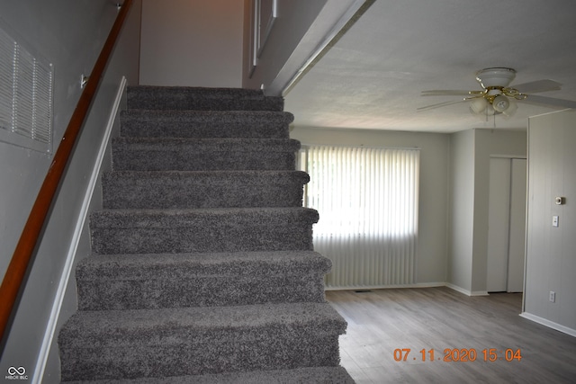 9016 Neptune Dr, Indianapolis, IN 46229 - stairway with wood finished floors and ceiling fan