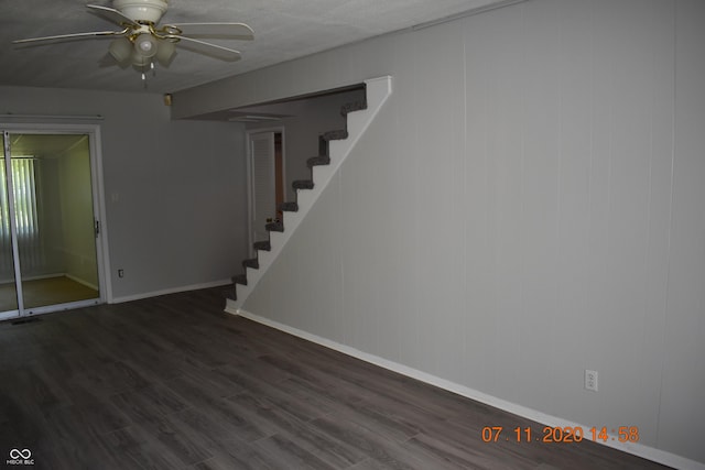 9016 Neptune Dr, Indianapolis, IN 46229 - below grade area featuring stairs, ceiling fan, and dark wood-style floors