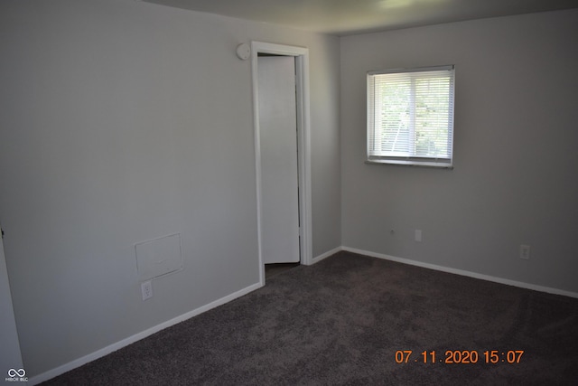 9016 Neptune Dr, Indianapolis, IN 46229 - unfurnished room featuring dark carpet and baseboards