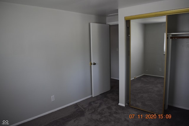 9016 Neptune Dr, Indianapolis, IN 46229 - unfurnished bedroom featuring dark carpet and a closet