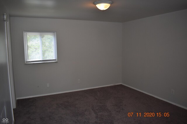 9016 Neptune Dr, Indianapolis, IN 46229 - empty room featuring dark carpet and baseboards