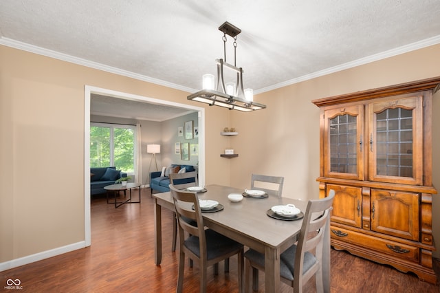 1031 Lancashire Ln, Pendleton, IN 46064 - dining area featuring dark wood-style flooring, crown molding, a textured ceiling, and a chandelier