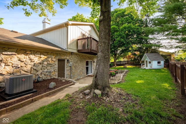 1031 Lancashire Ln, Pendleton, IN 46064 - fenced backyard featuring a balcony and an outbuilding