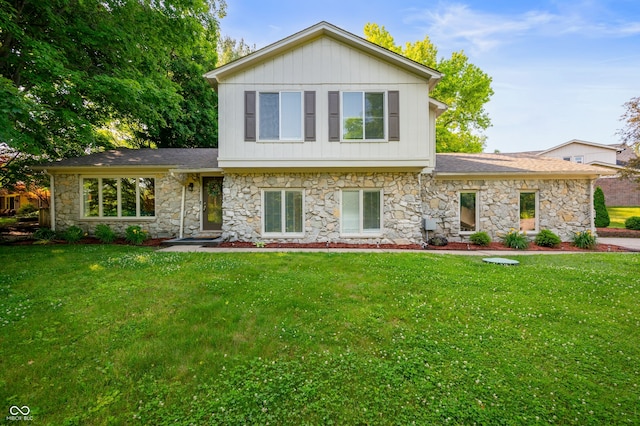 1031 Lancashire Ln, Pendleton, IN 46064 - view of front facade with stone siding, a front yard, and a shingled roof