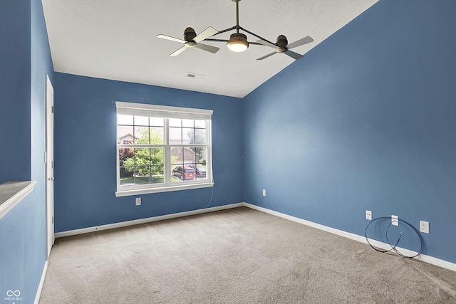 12322 Cool Winds Way W, Fishers, IN 46037 - spare room with carpet flooring, ceiling fan, vaulted ceiling, and a textured ceiling