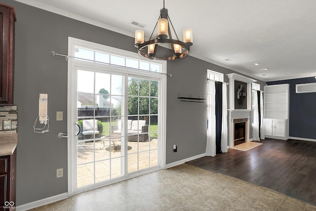 12322 Cool Winds Way W, Fishers, IN 46037 - unfurnished dining area with a chandelier, a fireplace, and crown molding