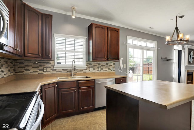 12322 Cool Winds Way W, Fishers, IN 46037 - kitchen with stainless steel appliances, crown molding, backsplash, and healthy amount of natural light