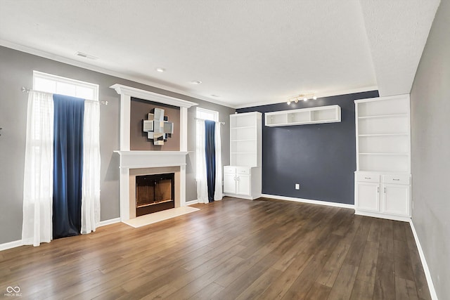 12322 Cool Winds Way W, Fishers, IN 46037 - unfurnished living room with a fireplace, dark wood-style flooring, a wall mounted AC, and crown molding